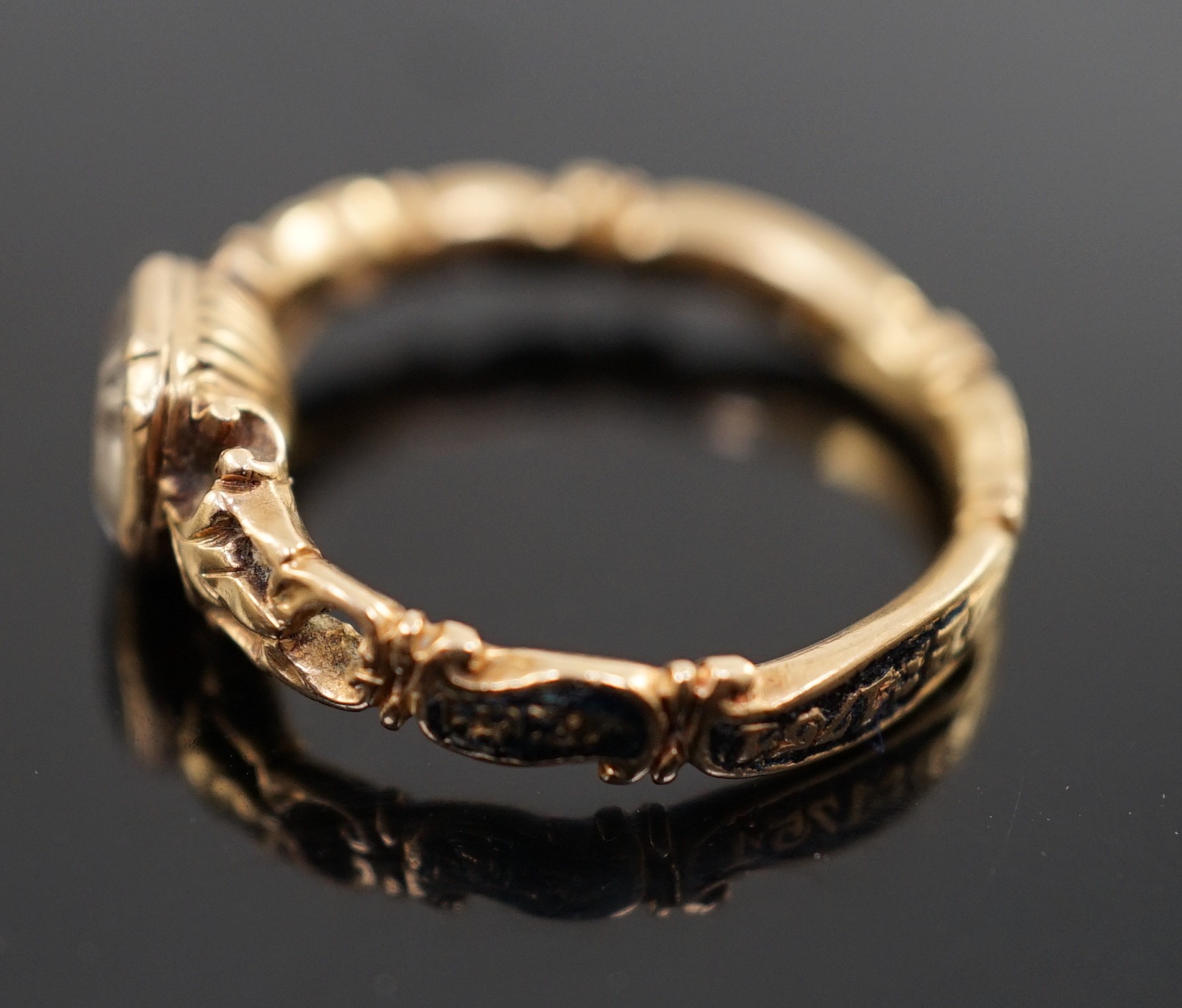 A George II gold, black enamel and rock crystal set mourning ring